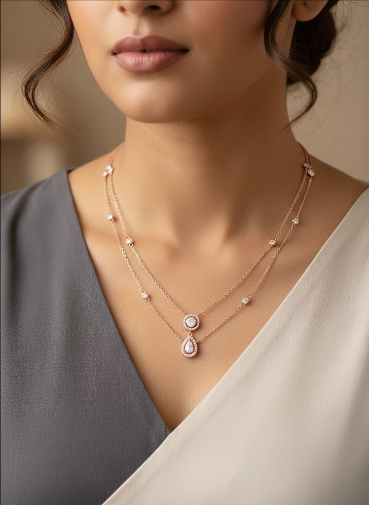 Woman wearing an 18K rose gold diamond layered drop necklace, ideal for Genz, Emirati and Khaleeji ladies for daily and party wear