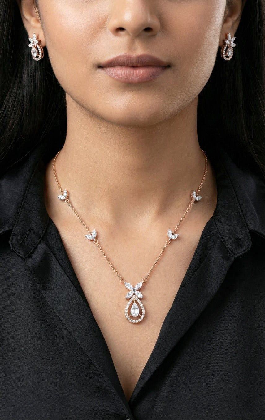 Lady wearing 18K rose gold diamond teardrop necklace set, evening and party wear for Emirati and Khaleeji women, J.H. Jewellers Dubai.