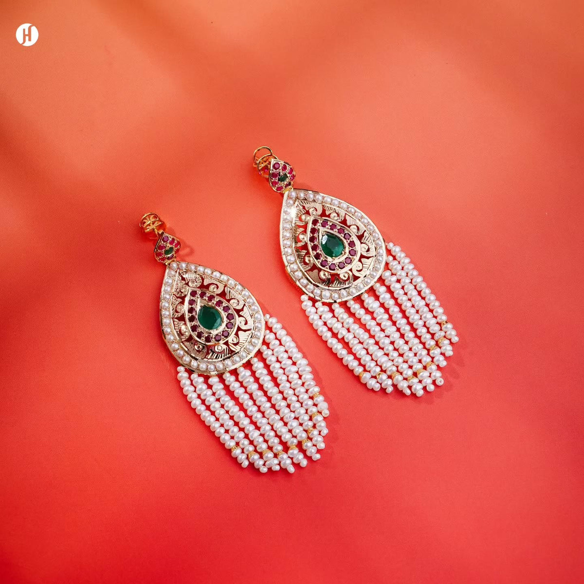 21Karat yellow gold Pakistani teardrop chandelier drop earrings with freshwater pearls and ruby-red and emerald-green stones, matching the pearl long bridal necklace set, loved by Emirati, Khaleeji and South Asian women, J.H Jewellers, Dubai & Sharjah, UAE.