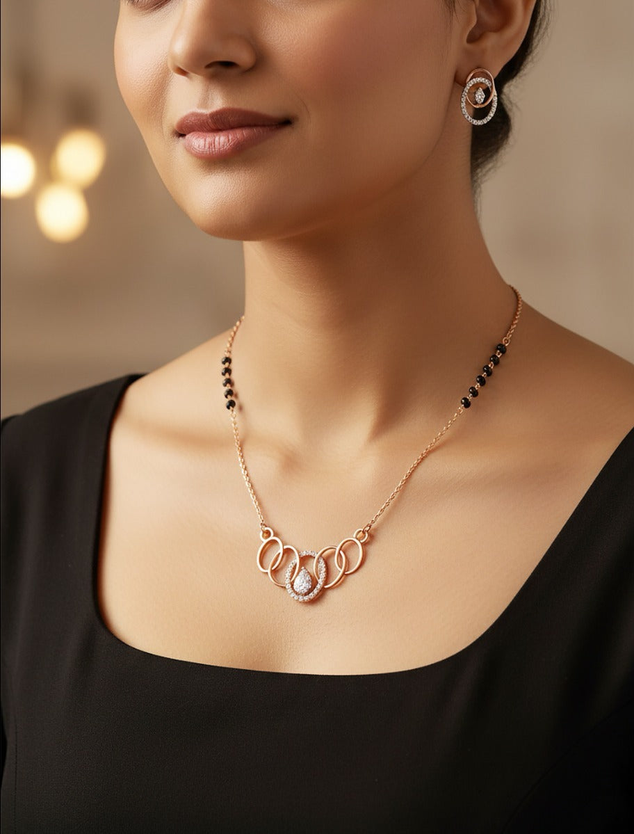 Woman wearing an 18K rose gold diamond interlocking circle necklace set, perfect for daily wear and gifting
