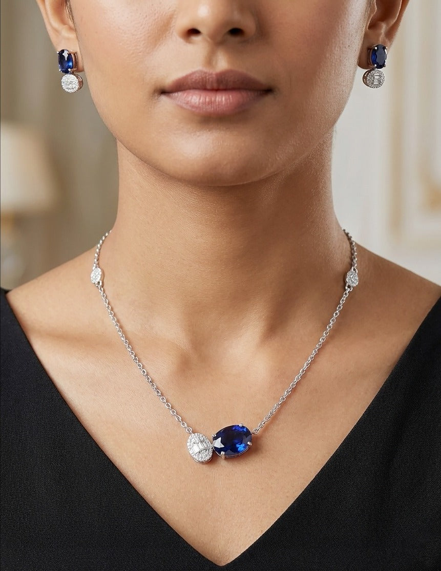 Lady wearing 18K white gold blue sapphire and diamond necklace set, evening and party wear for Emirati and Khaleeji women, J.H. Jewellers Dubai.