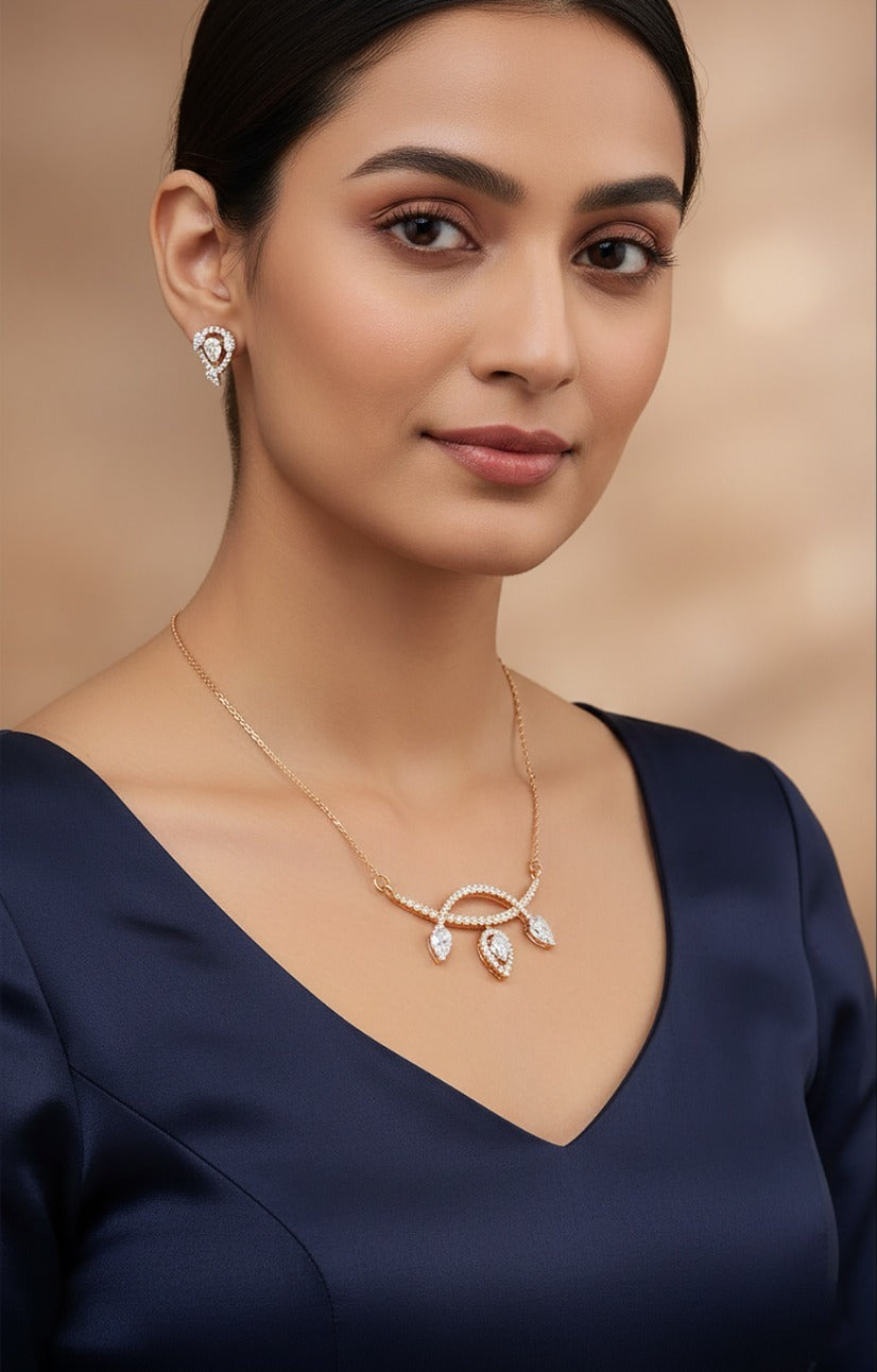 Lady wearing 18K yellow gold diamond leaf-drop necklace set, evening and party wear for Emirati and Khaleeji women, J.H. Jewellers Dubai.