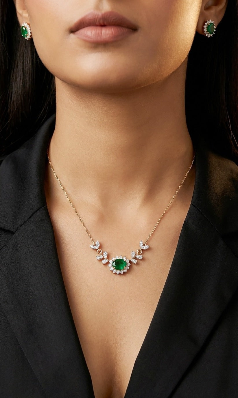 Lady wearing 18K yellow gold emerald and diamond necklace set, evening and party wear for Emirati and Khaleeji women, J.H. Jewellers Dubai.