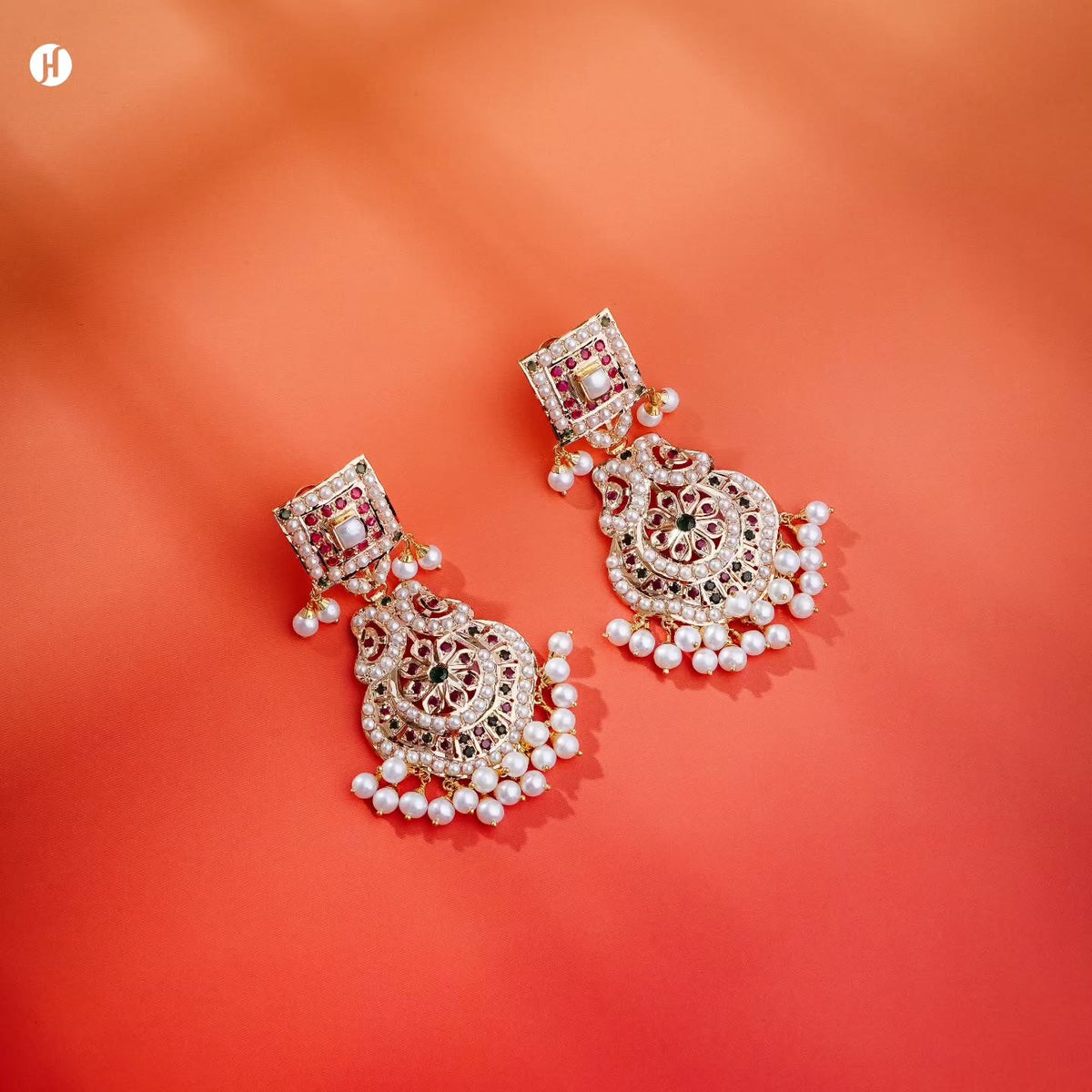21Karat yellow gold Pakistani chandelier drop earrings with freshwater pearls and ruby-red and emerald-green stones, matching the pearl rani haar bridal necklace set, loved by Emirati, Khaleeji and South Asian women, J.H. by Priyansh Jewellery, Dubai, UAE.