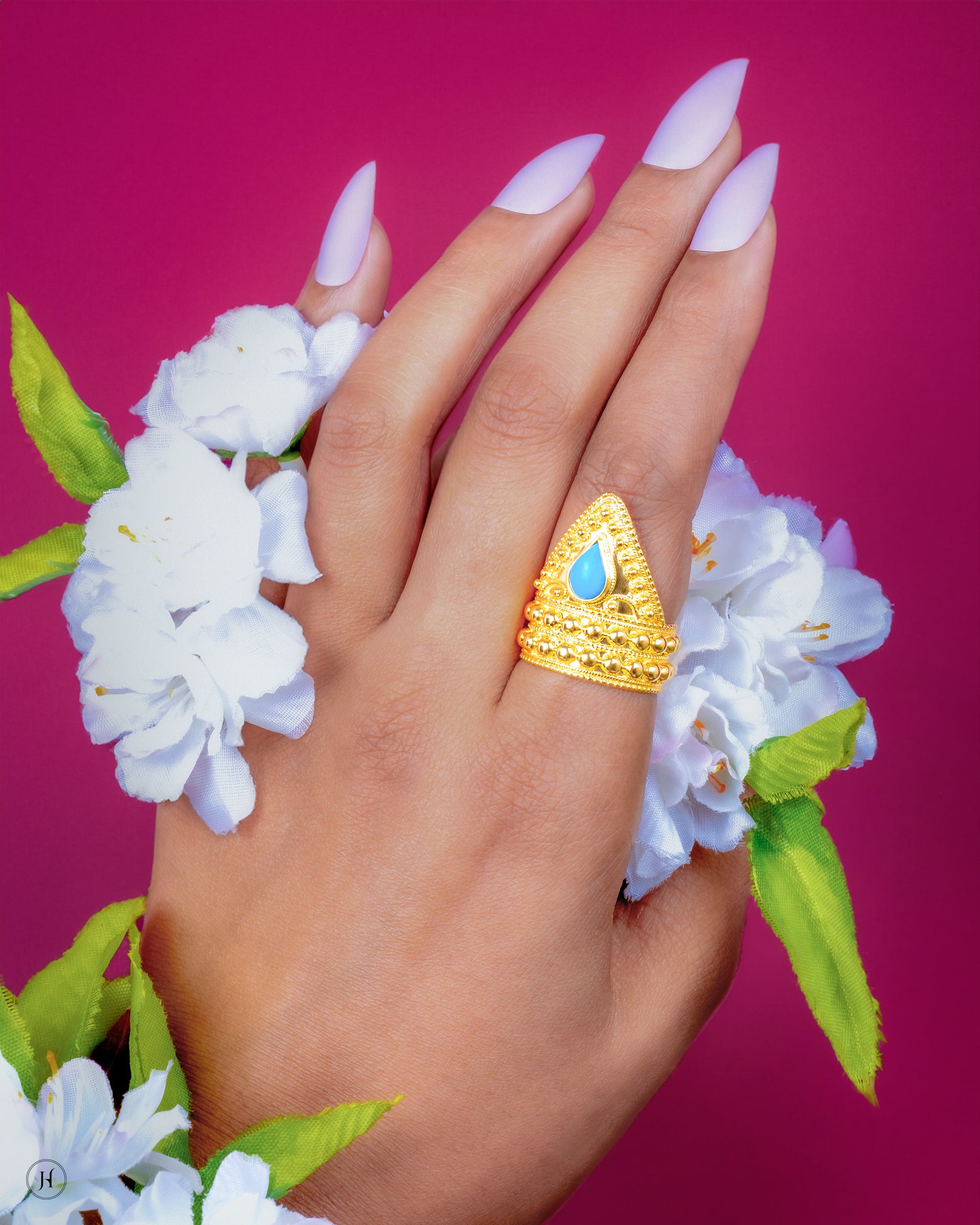 This 21K yellow gold Bahraini cone ring features&nbsp;a teardrop-shaped turquoise stone.&nbsp;An affordable gift option for your daughter, girlfriend, wife or fiancée that can be worn for special functions.
