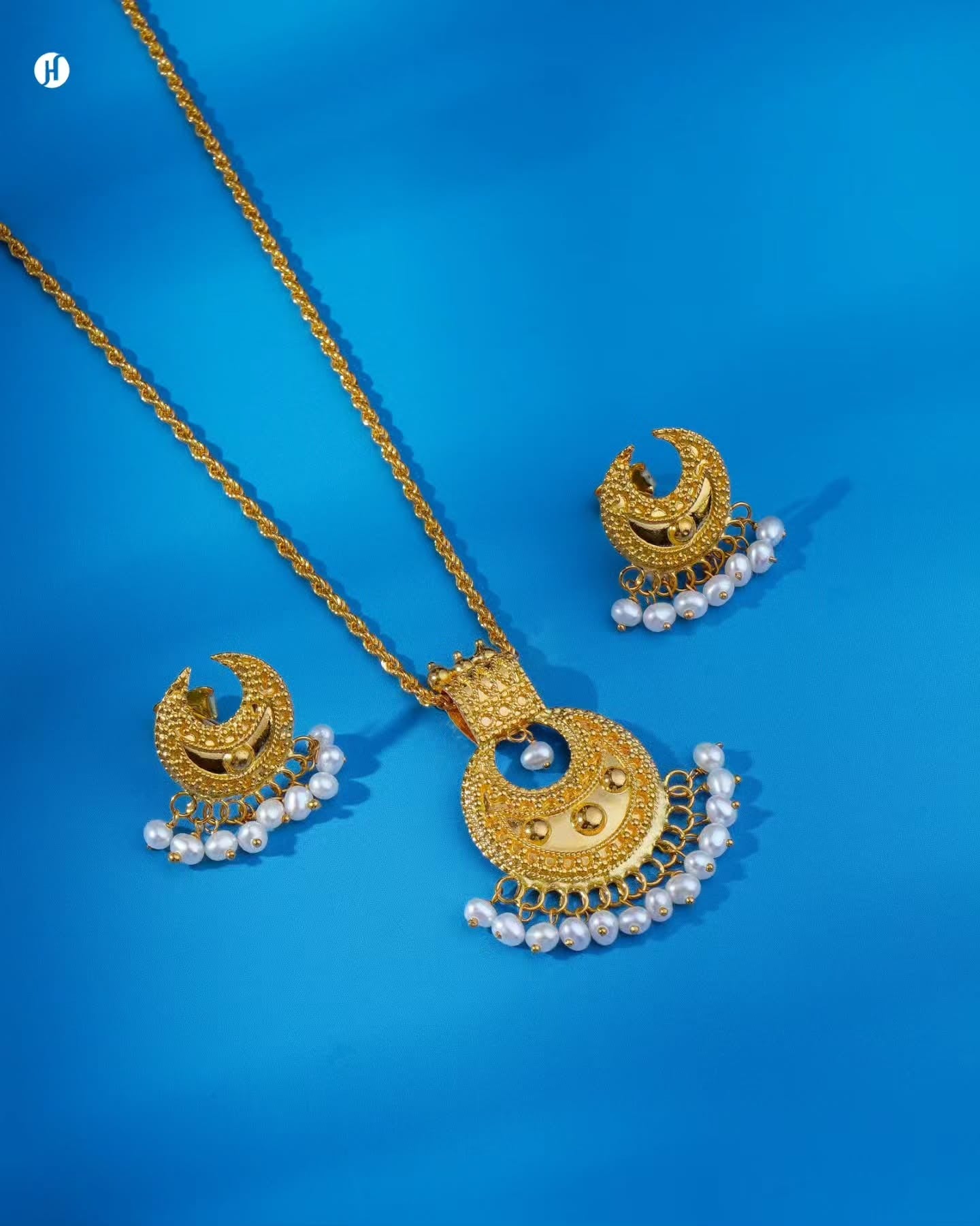 21K yellow gold Bahraini crescent pearl pendant set with matching crescent drop earrings and freshwater pearl fringe — Emirati and Khaleeji women's jewellery, Dubai, UAE.