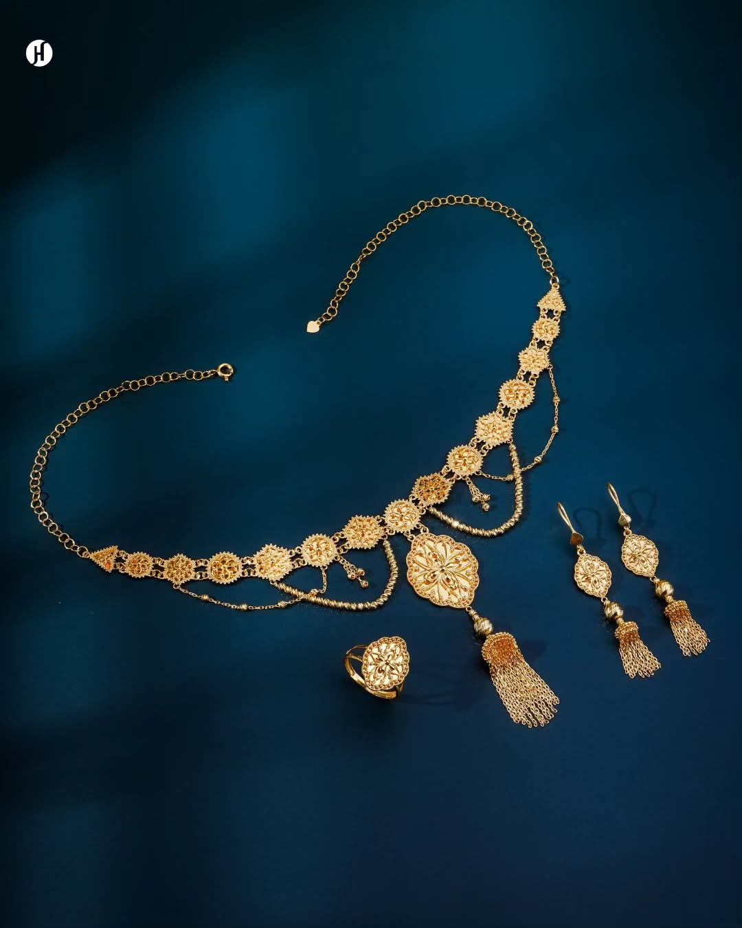 21K yellow gold Bahraini floral medallion tassel necklace set with matching earrings and ring, loved by Emirati and Khaleeji women, J.H. Jewellers, Shop No. 13/14, Block No. 8, New Central Market, Sharjah, UAE.