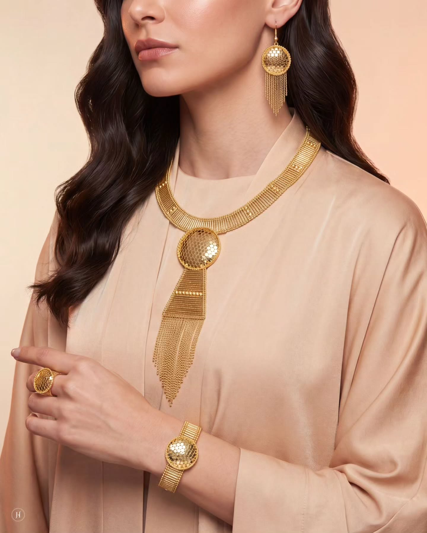 Lady wearing 21K yellow gold Bahraini mesh-textured circular medallion necklace set with drop earrings, bracelet and ring — Emirati and Khaleeji bridal jewellery, Dubai, UAE.