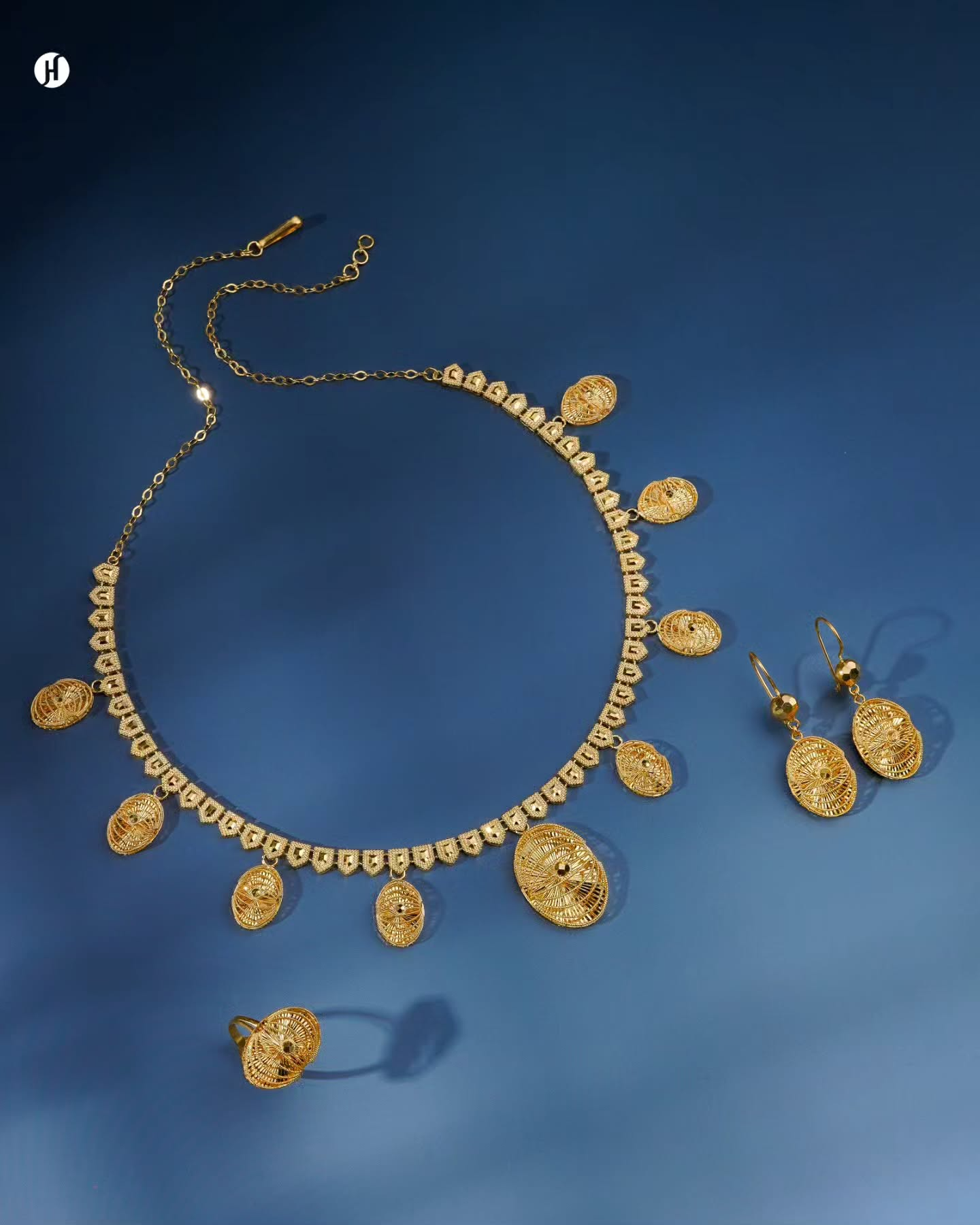 21K yellow gold Bahraini openwork oval charm necklace set with matching earrings and ring, loved by Emirati and Khaleeji women, Dubai, UAE.