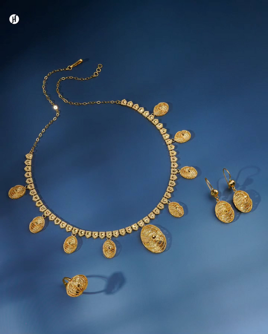 21K yellow gold Bahraini openwork oval charm necklace set with matching earrings and ring, loved by Emirati and Khaleeji women, Dubai, UAE.