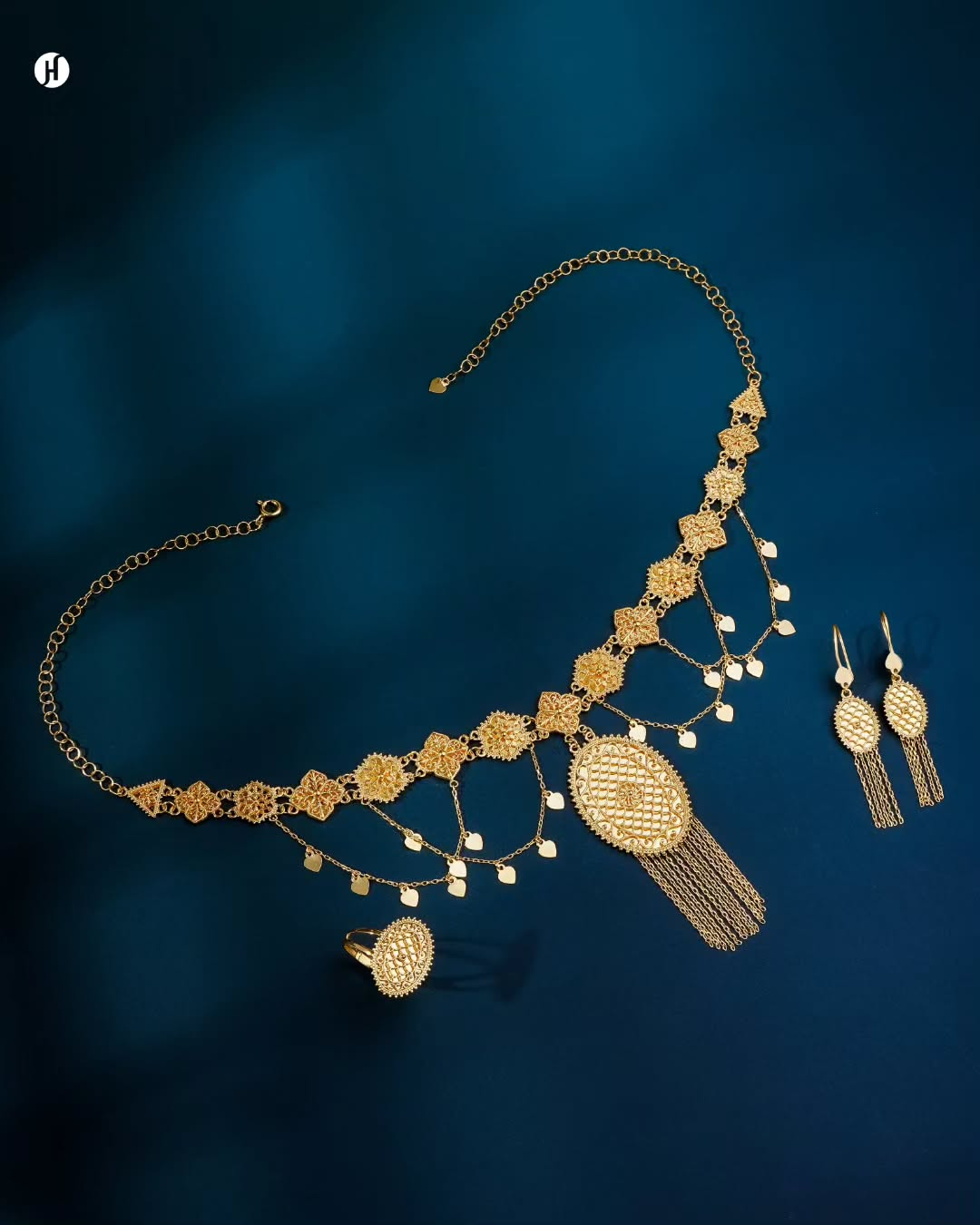 21K yellow gold Bahraini oval medallion tassel necklace set with matching earrings and ring, loved by Emirati and Khaleeji women, J.H. Jewellers, Shop No. 13/14, Block No. 8, New Central Market, Sharjah, UAE.