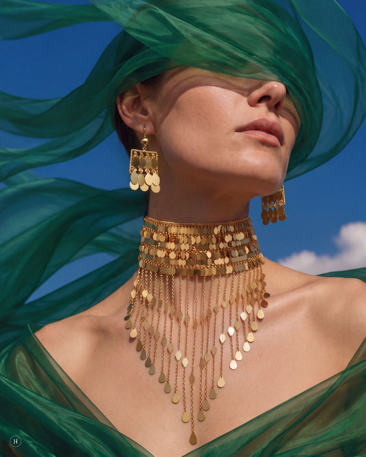 Lady wearing a 21K yellow gold Bahraini sequin fringe choker necklace and matching fringe earrings, bridal statement jewellery for Emirati and Khaleeji women, J.H. by Priyansh Jewellery, Dubai, UAE.