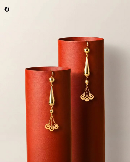 21K yellow gold Bahraini teardrop star tassel drop earrings with pierced star-disc charms — Emirati and Khaleeji women's jewellery, Dubai, UAE.