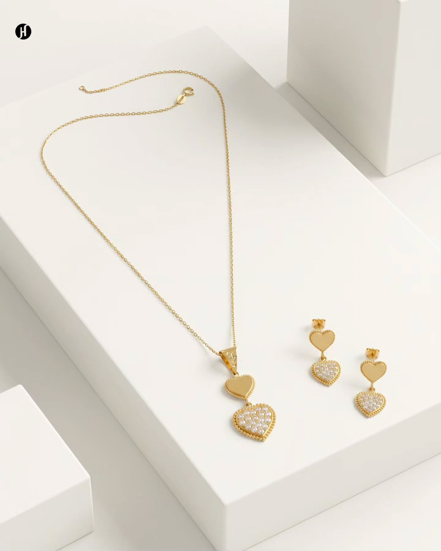 21K yellow gold double heart pendant necklace set with pavé heart and matching drop earrings — a love gift for Emirati and Khaleeji women, Dubai, UAE.