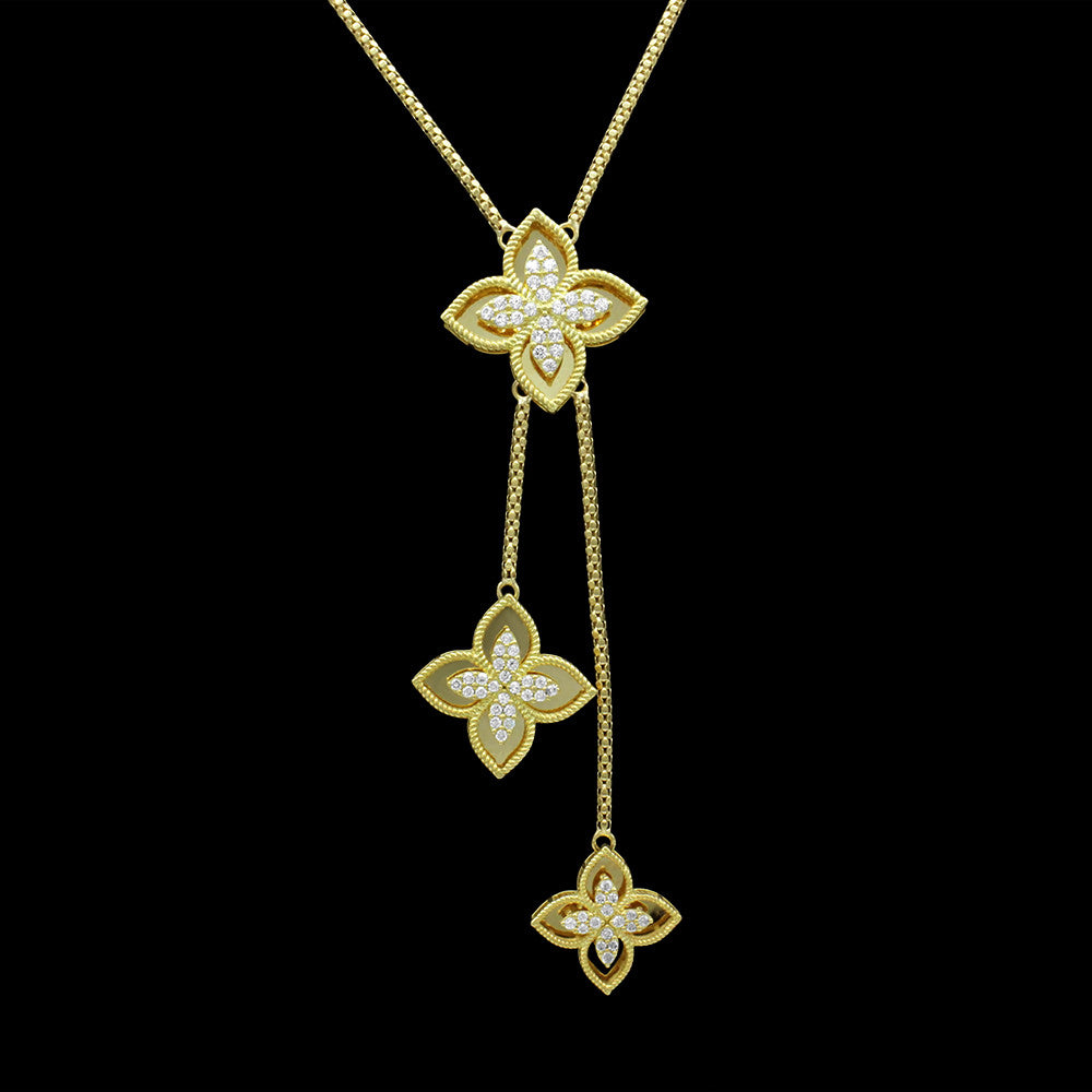 Close up of 18K Yellow Gold Italian Symmetric 4-Petal Lotus Dangle Necklace