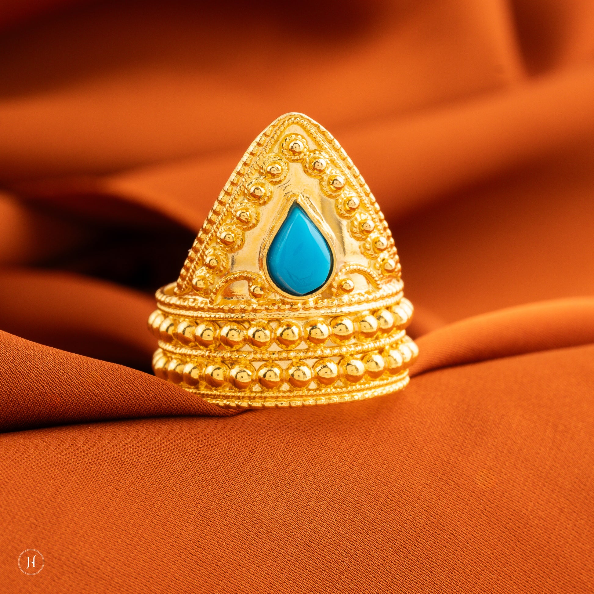 This 21K yellow gold Bahraini cone ring features&nbsp;a teardrop-shaped turquoise stone.&nbsp;An affordable gift option for your daughter, girlfriend, wife or fiancée that can be worn for special functions.